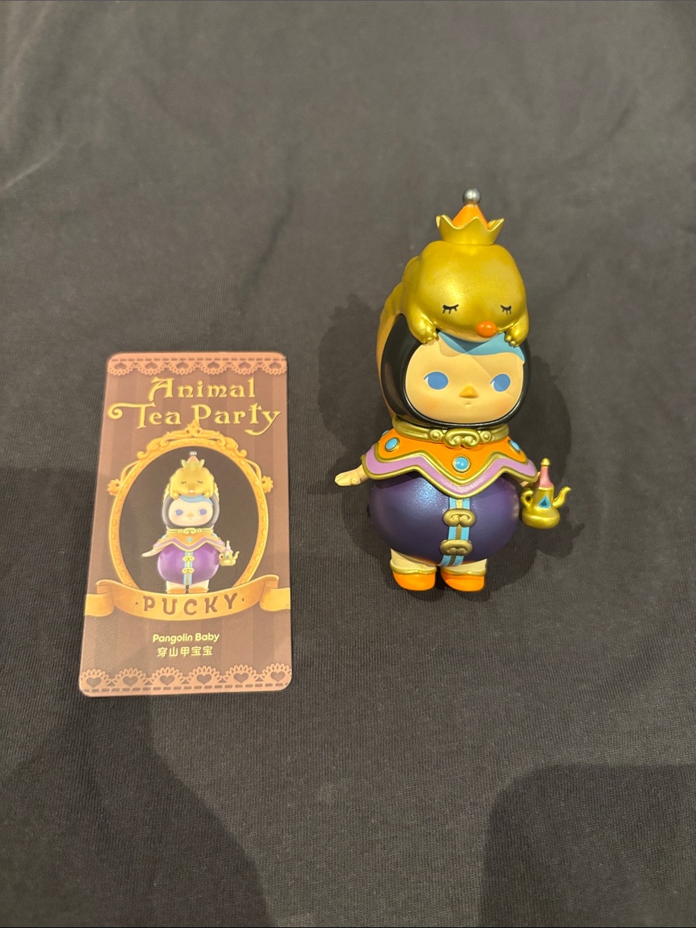 Animal Tea Party Pucky Pangolin Baby Figure - Purple & Gold